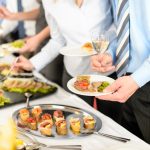 Business people take buffet appetizers
